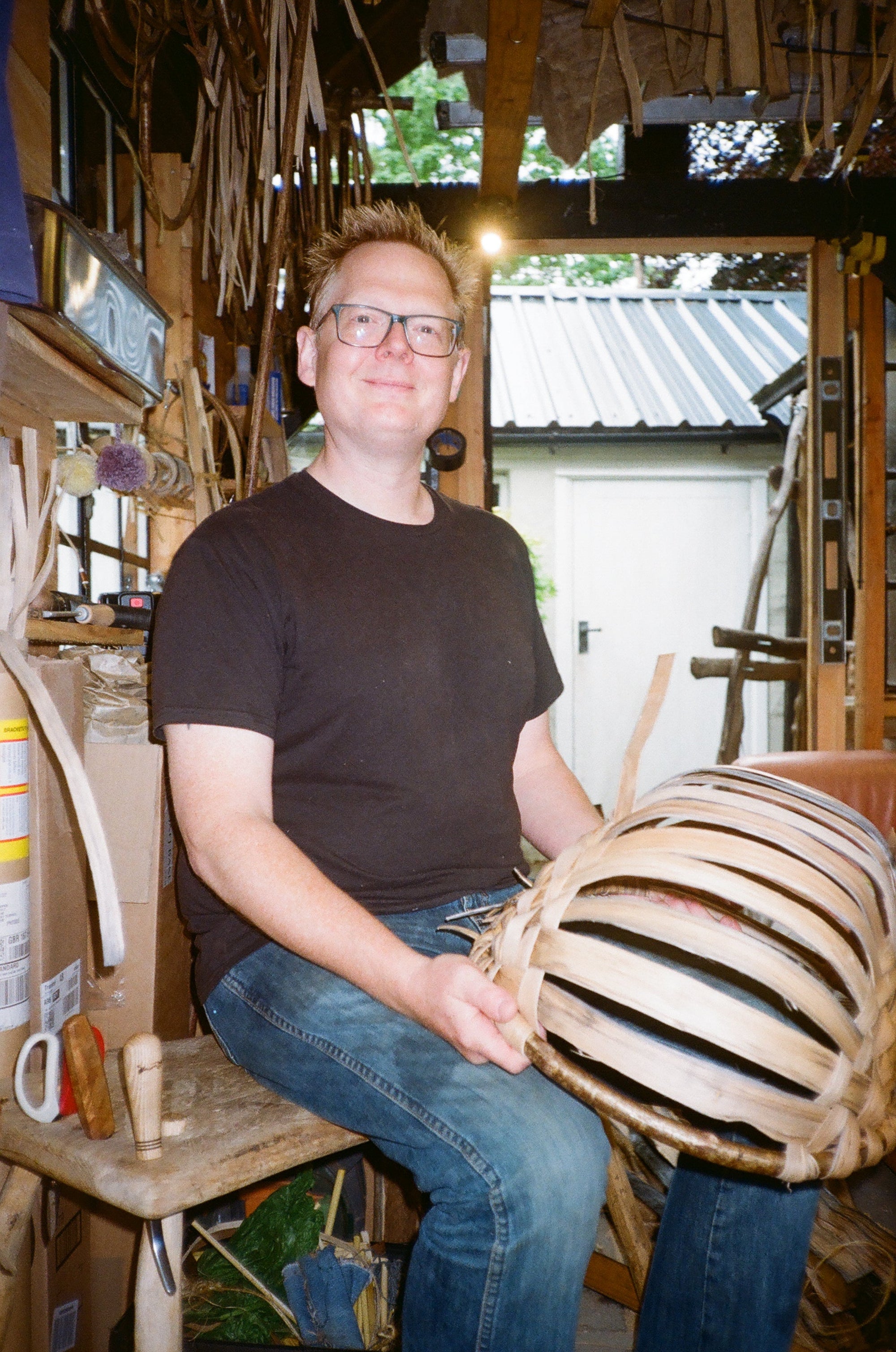 Person working on a wooden object in a workshop