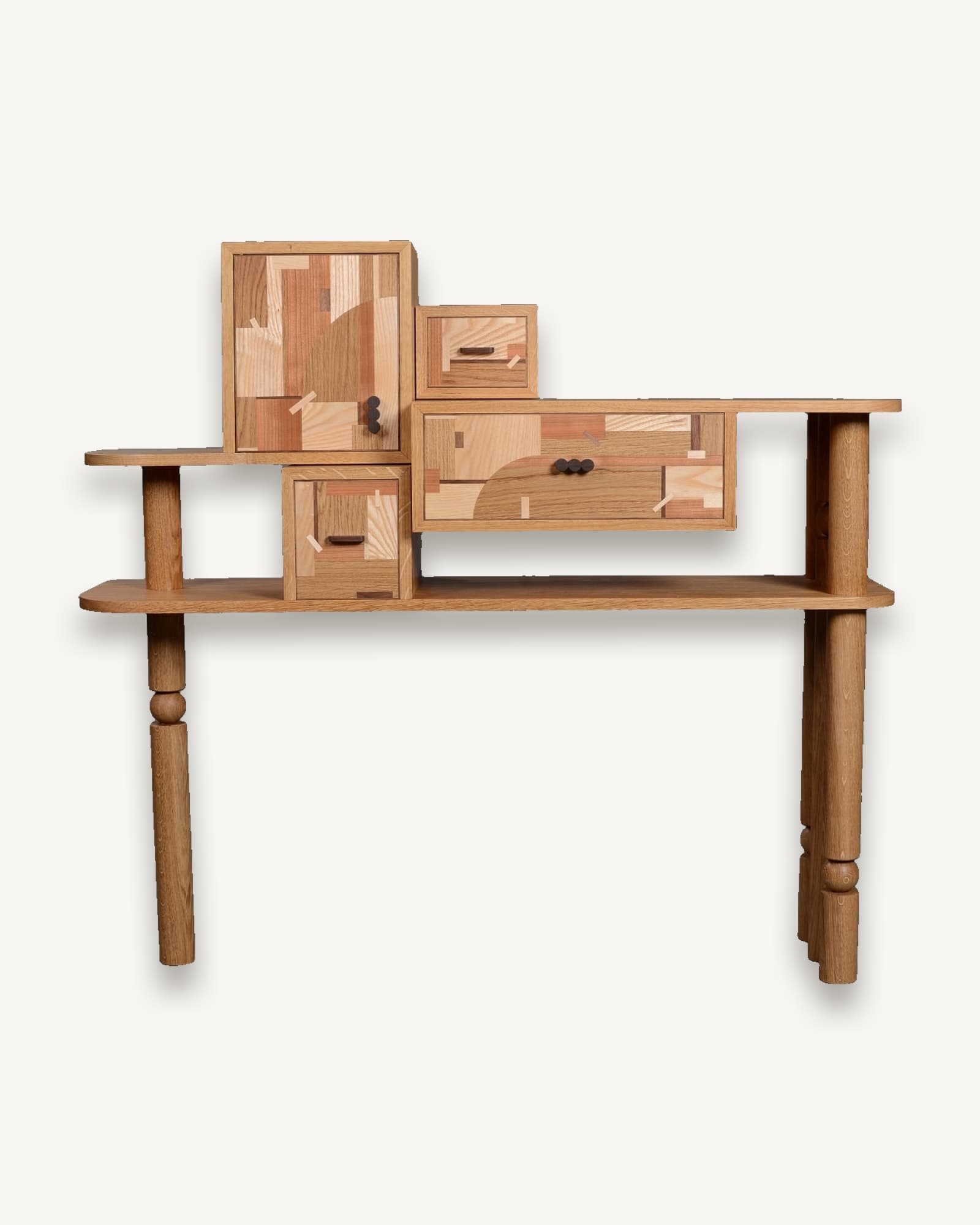 Oak console table with asymmetrical shelving and stacked wooden modules, featuring marquetry-decorated drawers and cupboard,