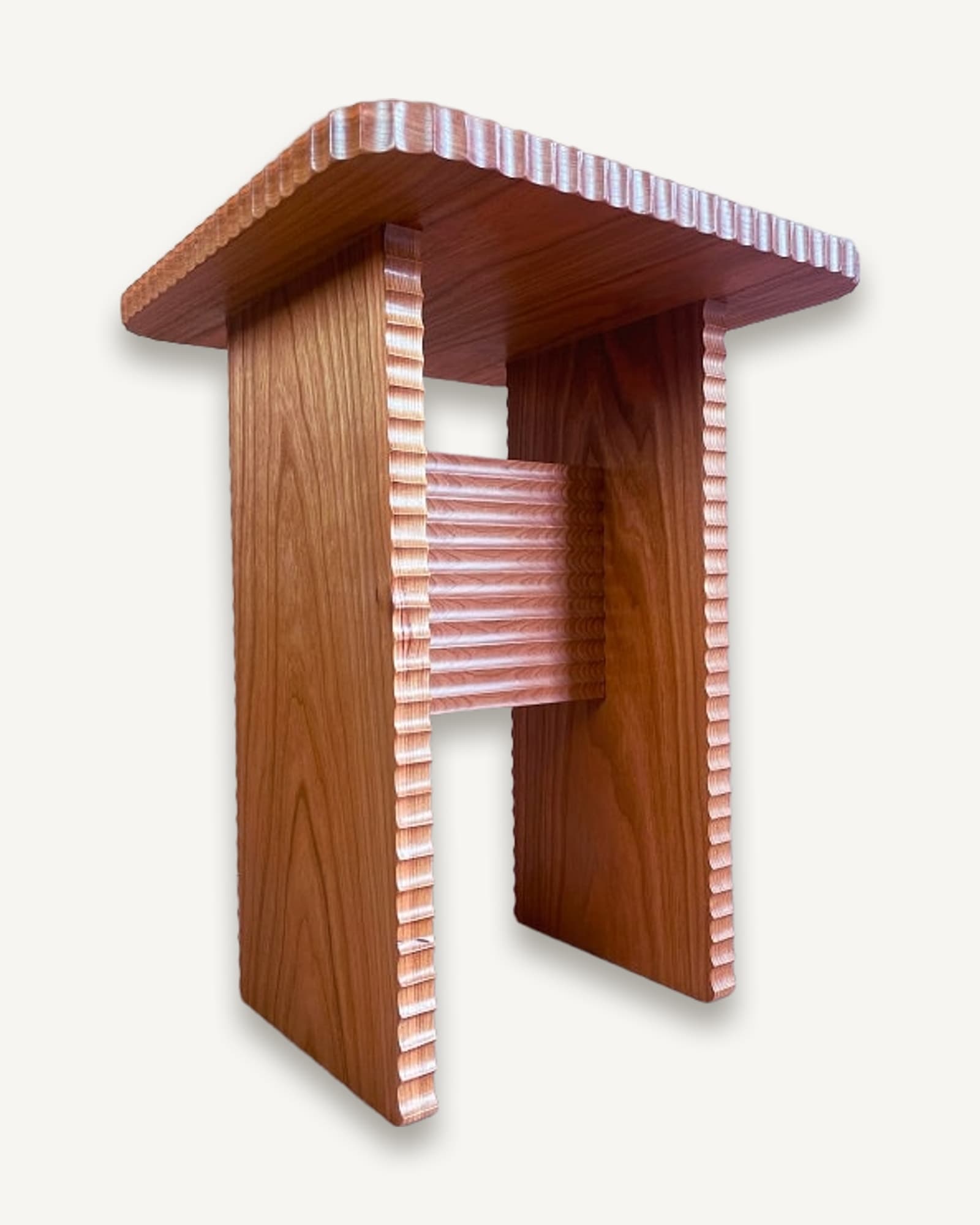 Small cherry side table with hand-carved fluted details on edges, open frame design with horizontal slats and overhanging