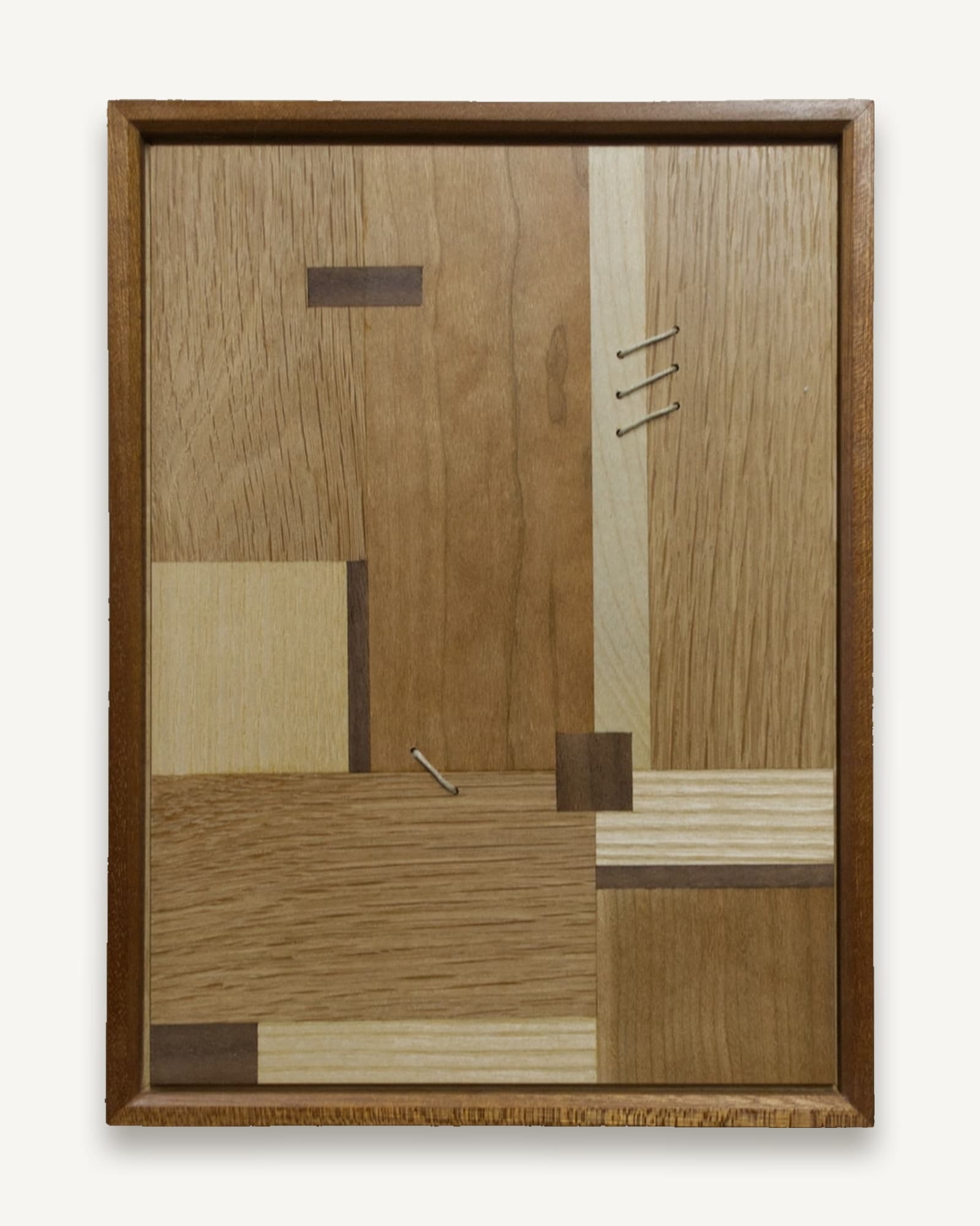 Framed wooden marquetry panel with geometric blocks of oak, ash, cherry, walnut and sycamore in varying tones. Metal