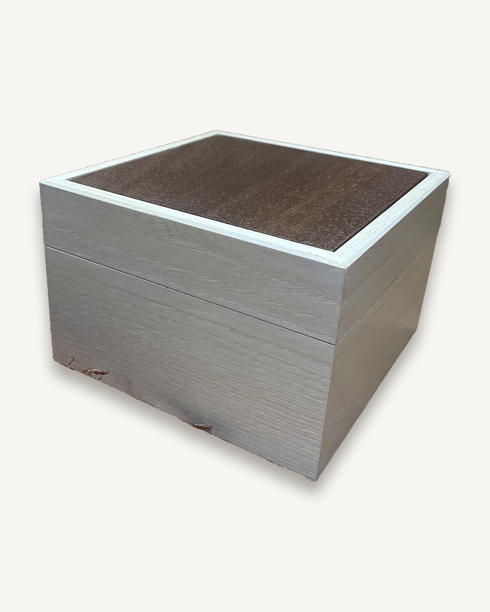 Pale ash wooden box with dark brown textured lid and small wooden feet, shown against white background.