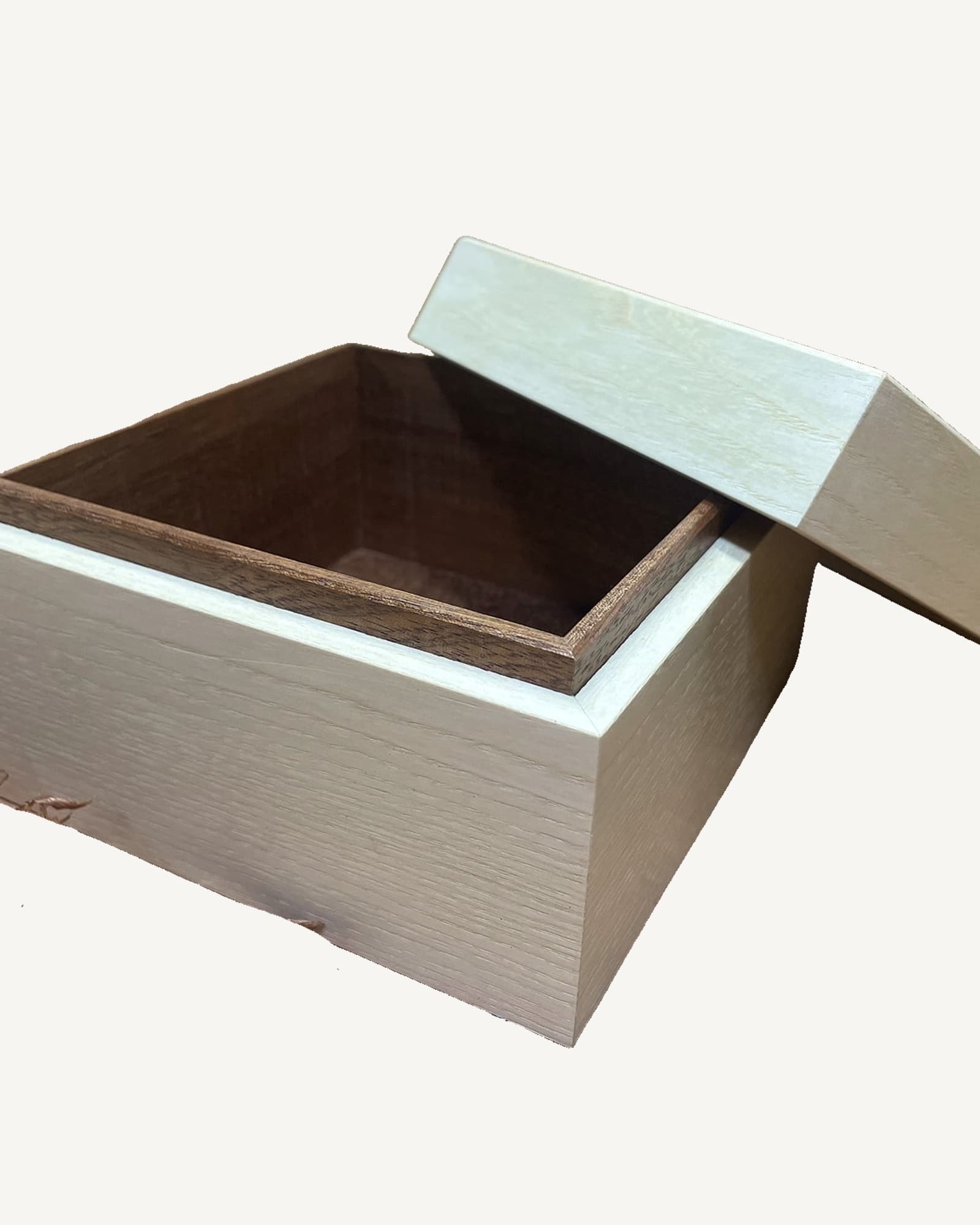 Light oak box with pale blue-grey lift-off lid, open to reveal dark interior. Dovetail joints visible on sides.