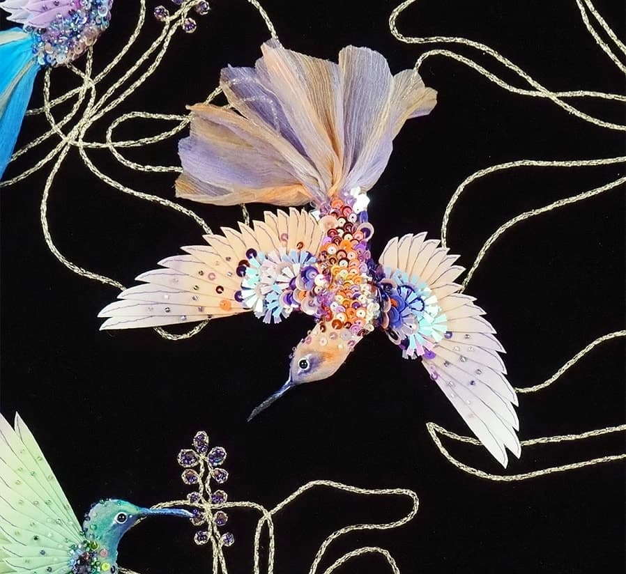 Detail of a hand-dyed silk hummingbird with beaded and sequinned wings