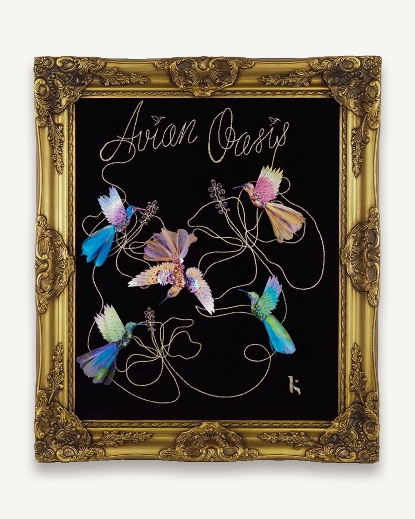Framed textile artwork in a gilt frame: silk hummingbirds on a black ground with fine gold linework