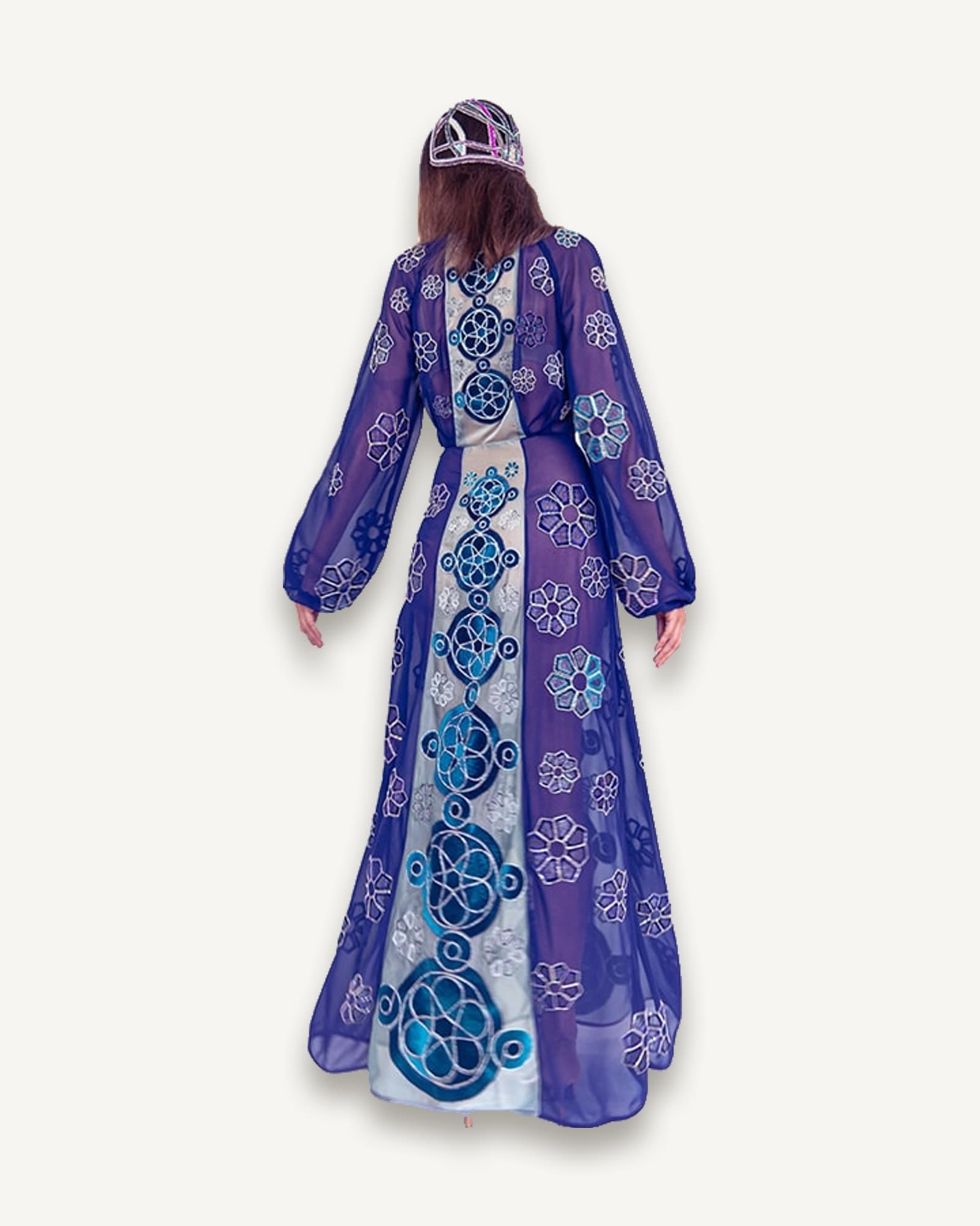 Purple chiffon maxi dress with hand-embroidered solar motifs, worn with a beaded kokoshnik headpiece, seen from behind