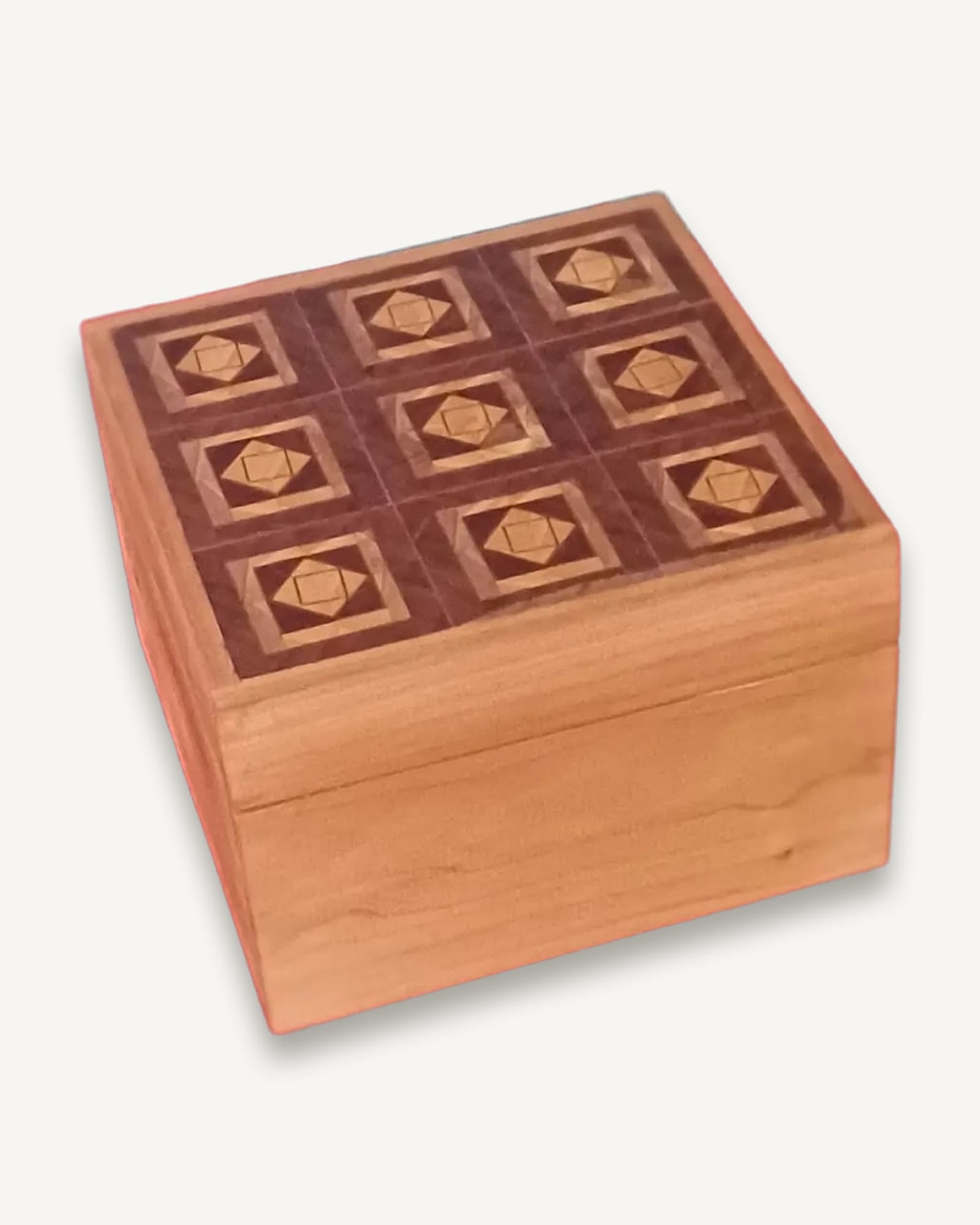A cherry box with a lid of nine panels, each a pale diamond set inside a darker square.