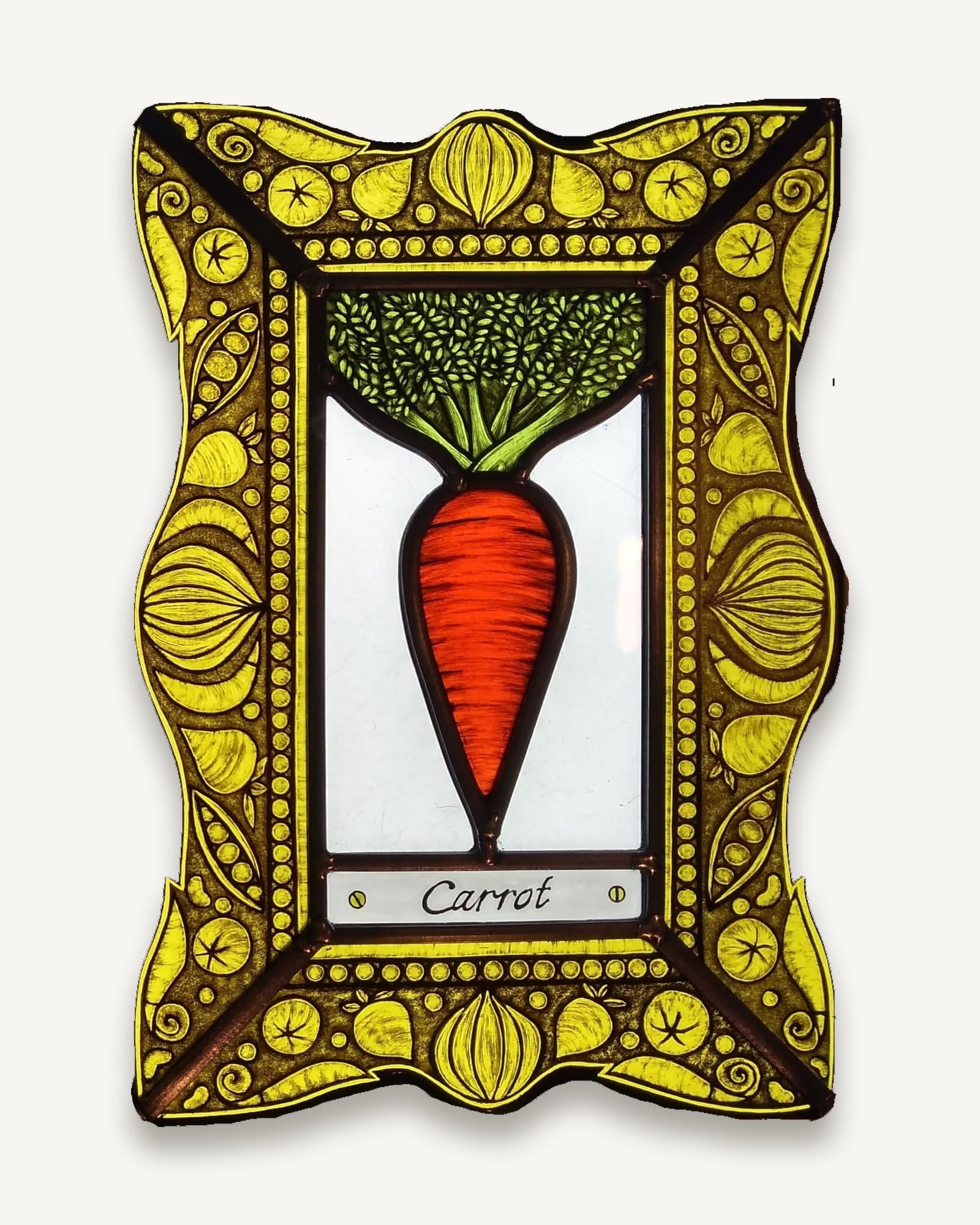 A stained glass kitchen garden panel: a painted carrot over a nameplate, inside a yellow border of stylised bulbs and seed heads.