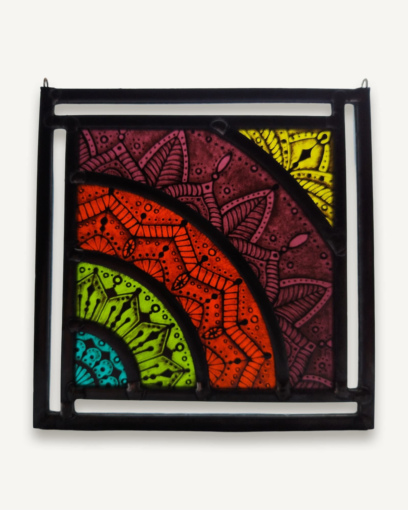 A square stained glass panel of concentric painted arcs in turquoise, lime, orange and deep pink, every band densely drawn.