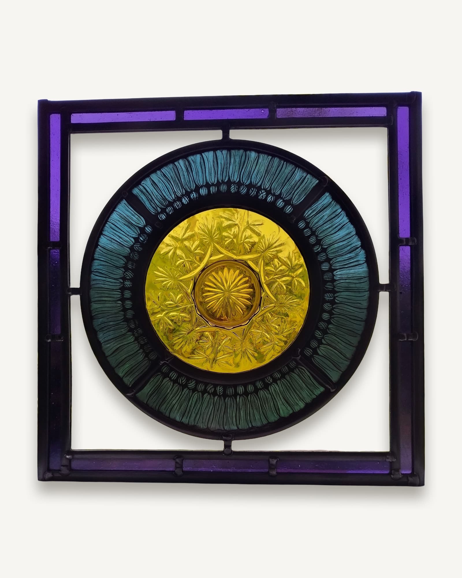 A large vintage pressed-glass plate leaded into the centre of a painted band of amber swags and tassels.
