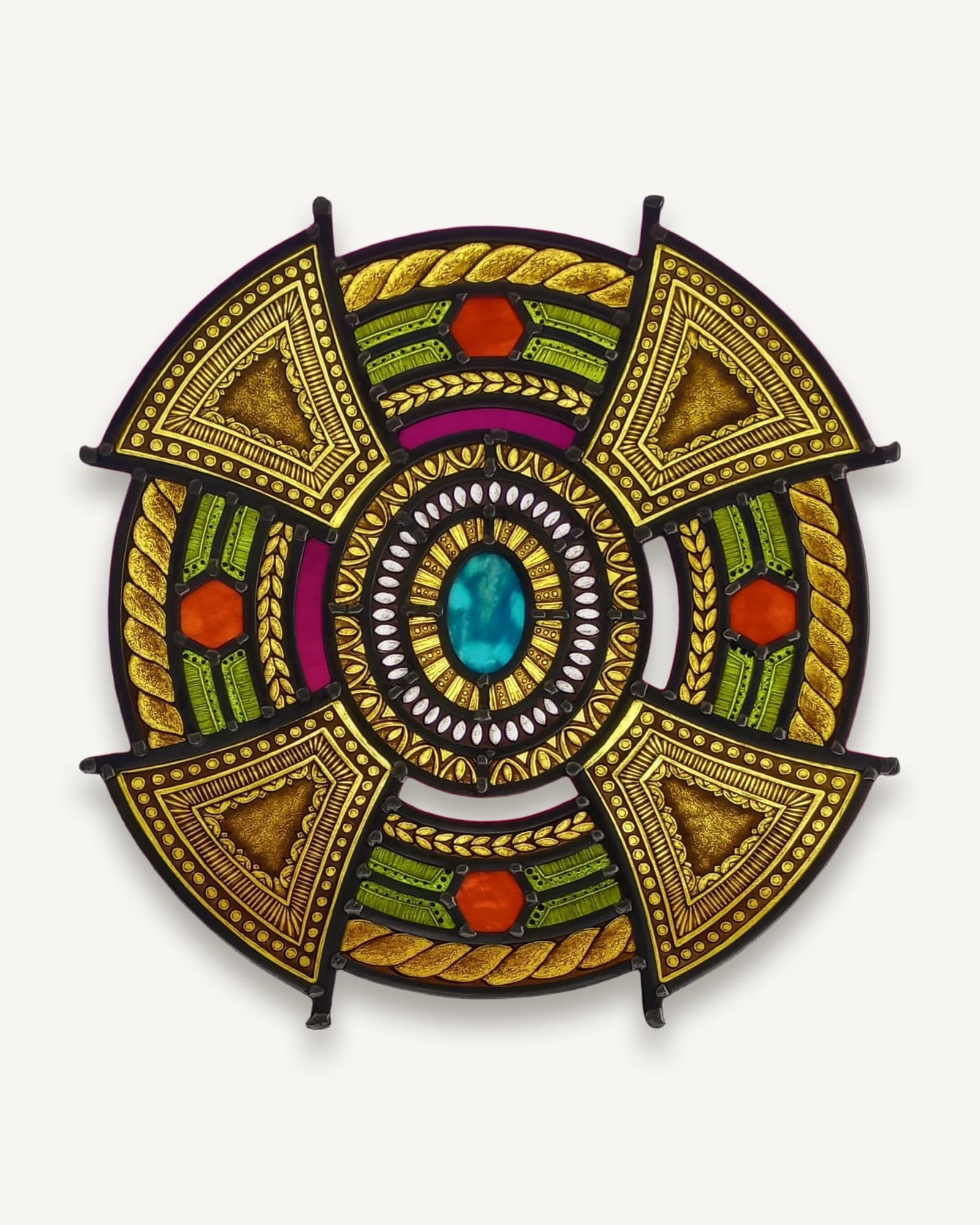 A painted gold and amber mandala on a magenta glass ground, turning around a turquoise oval.