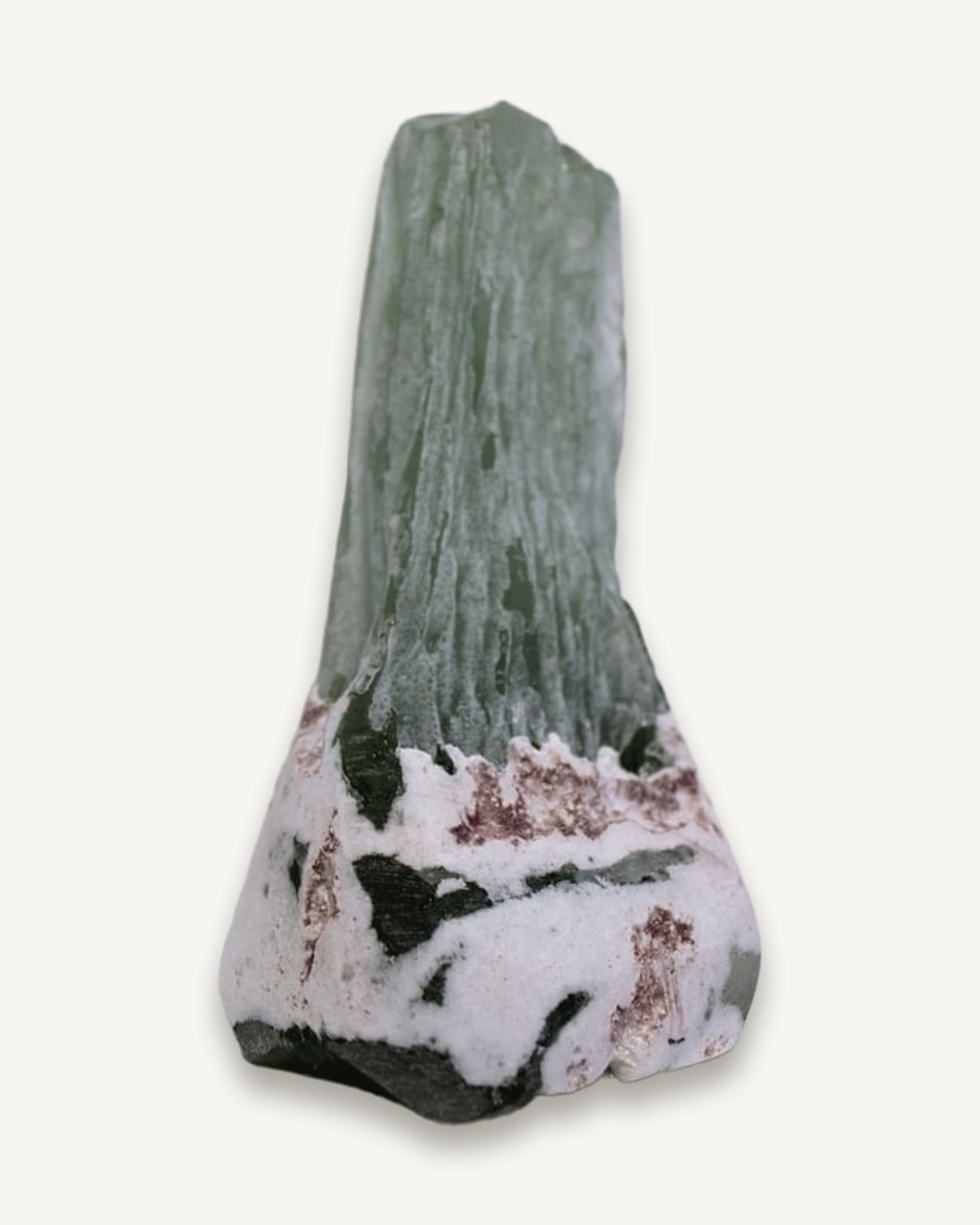 A tall wood-fired ceramic form with a pale green glazed top