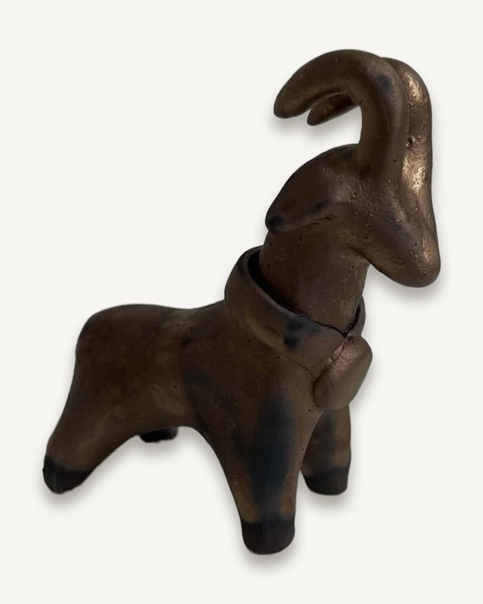 Bronze standing ram with curved horn and decorative band around neck featuring a raised medallion detail