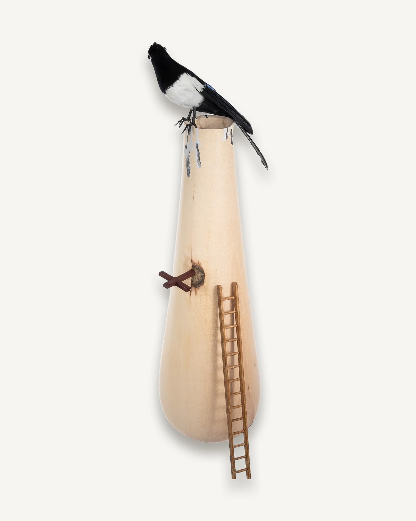 Pale beech vessel with magpie perched on rim, small wooden ladder leaning against side
