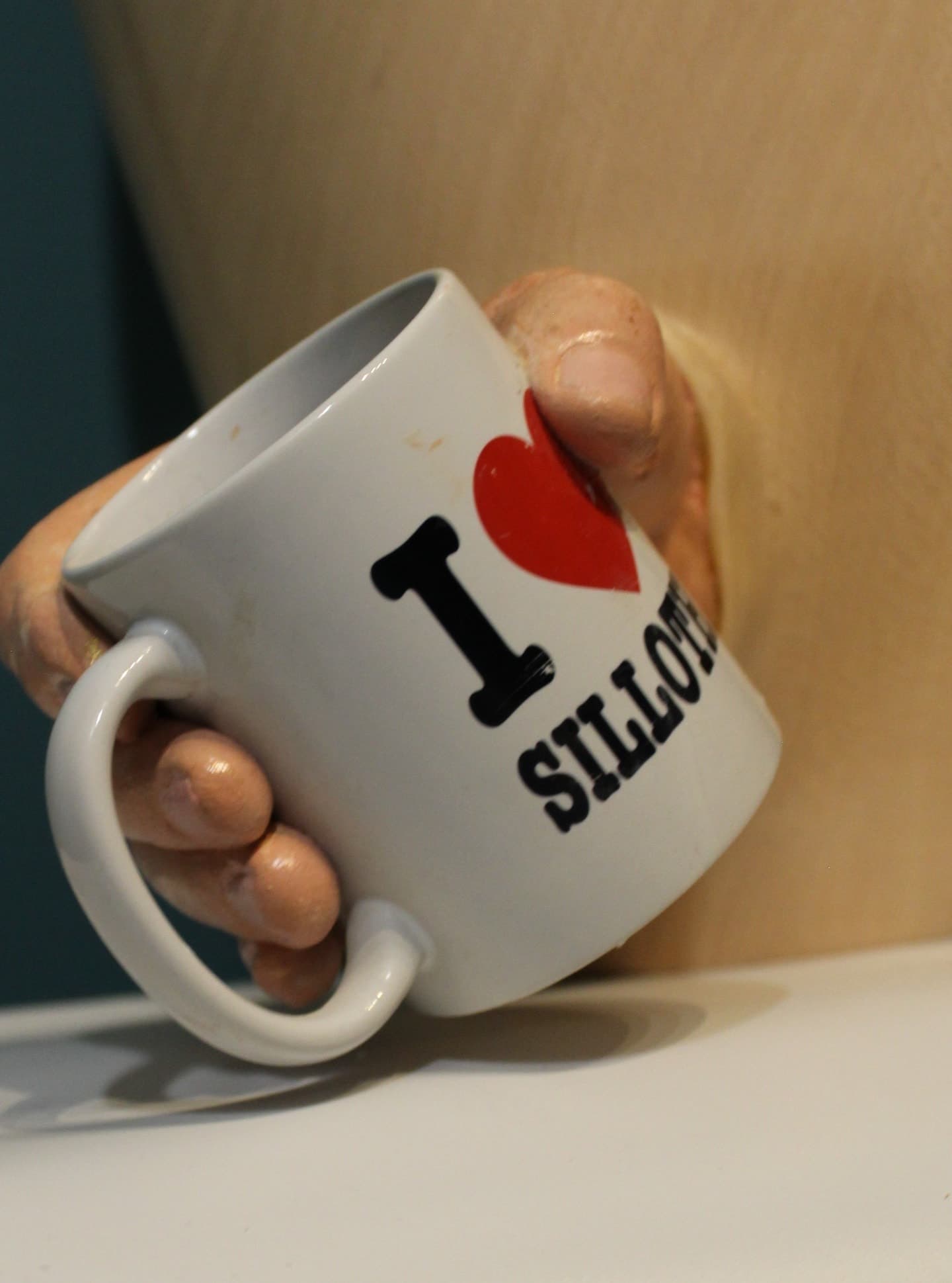 White ceramic mug printed with red heart and black text reading "I heart Silloth"
