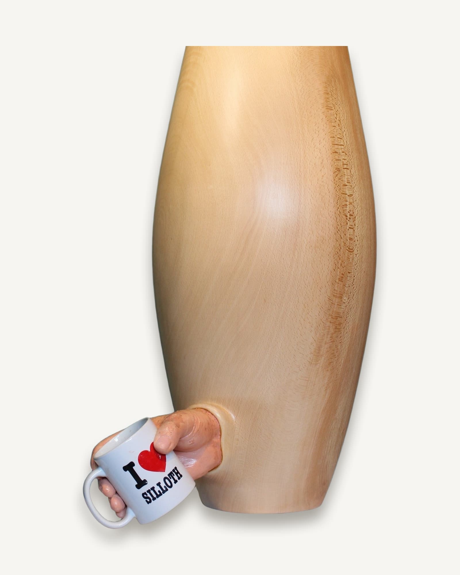 Pale wood vase with a carved human hand emerging from its side