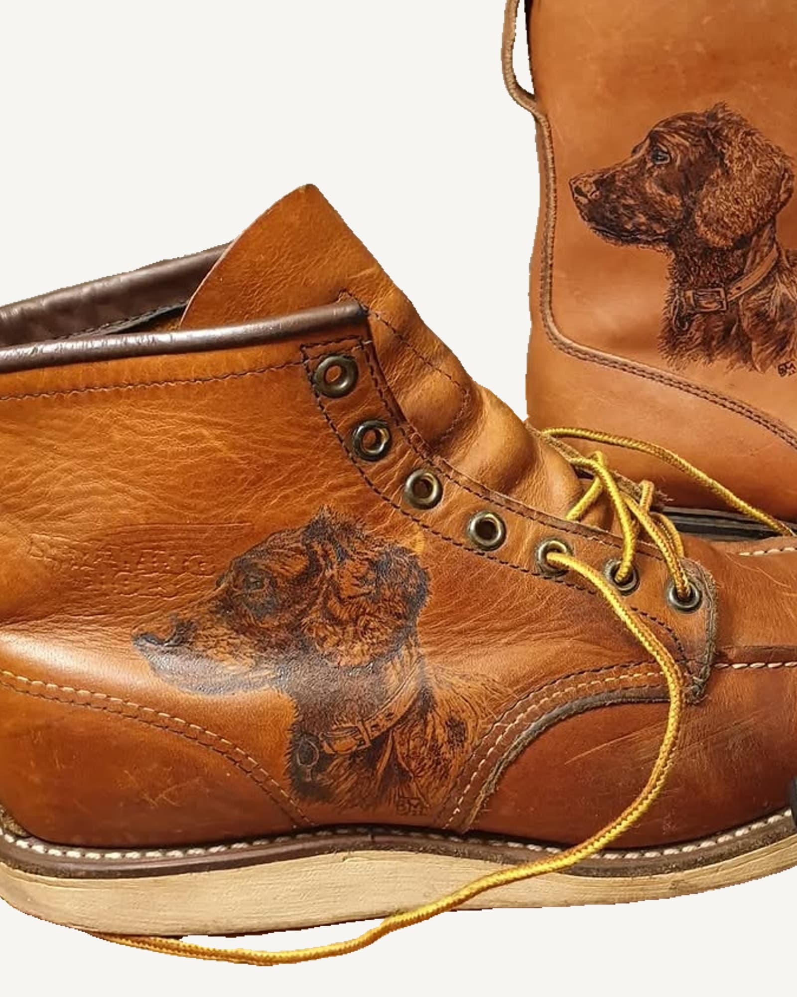 Pair of tan leather boots with spaniel portraits burned into the leather