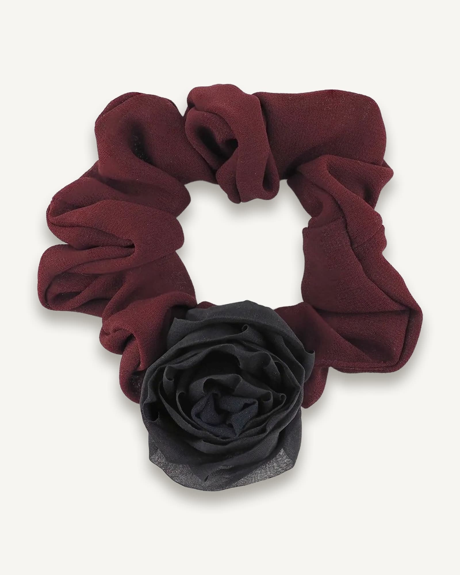 Maroon chiffon scrunchie gathered in a circle with a black silk rose bloom attached at the bottom.