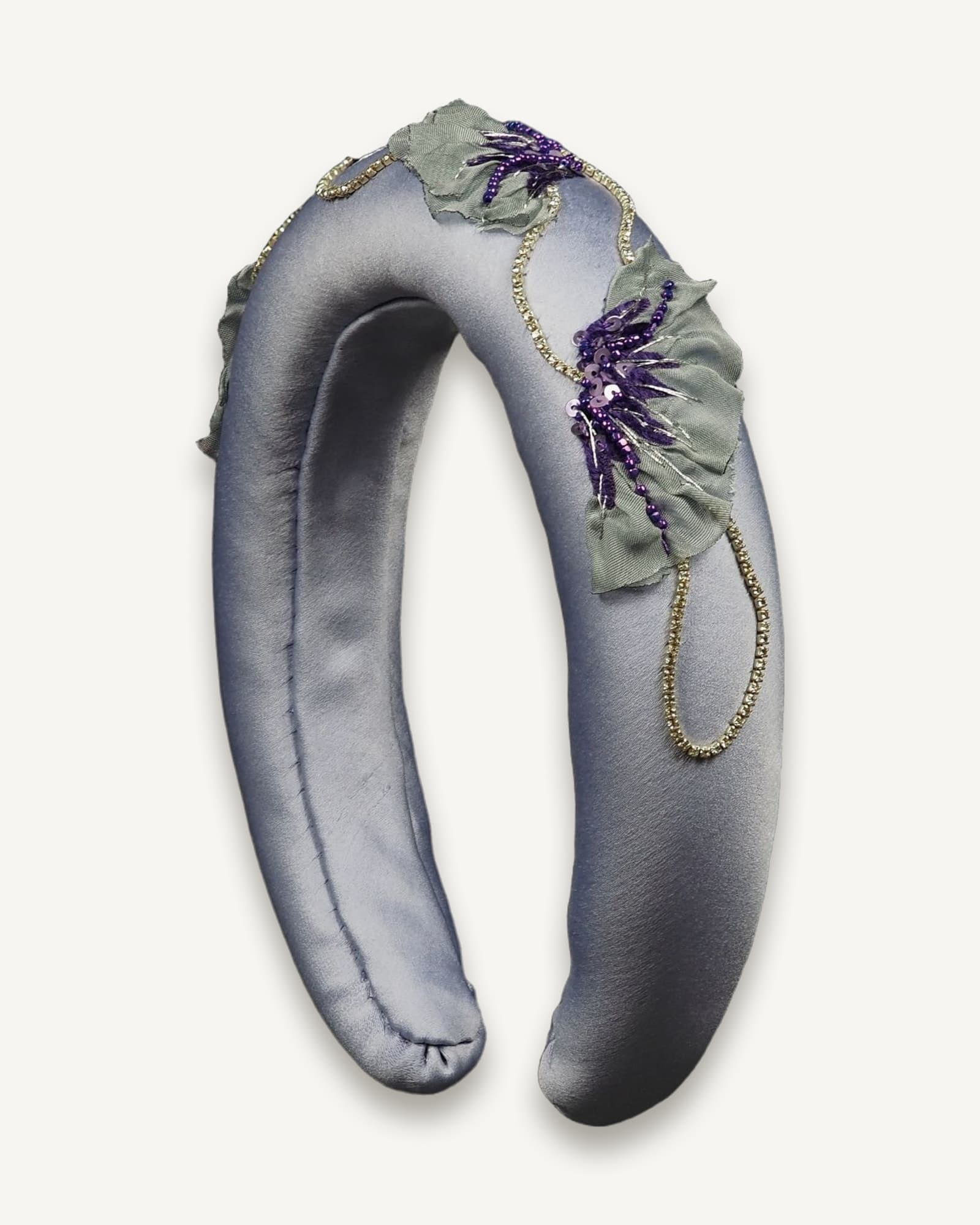 One-of-a-kind lavender satin headband featuring hand-embroidered purple poppy motifs with grey chiffon petals, sequins, and rhinestone chain, displayed upright