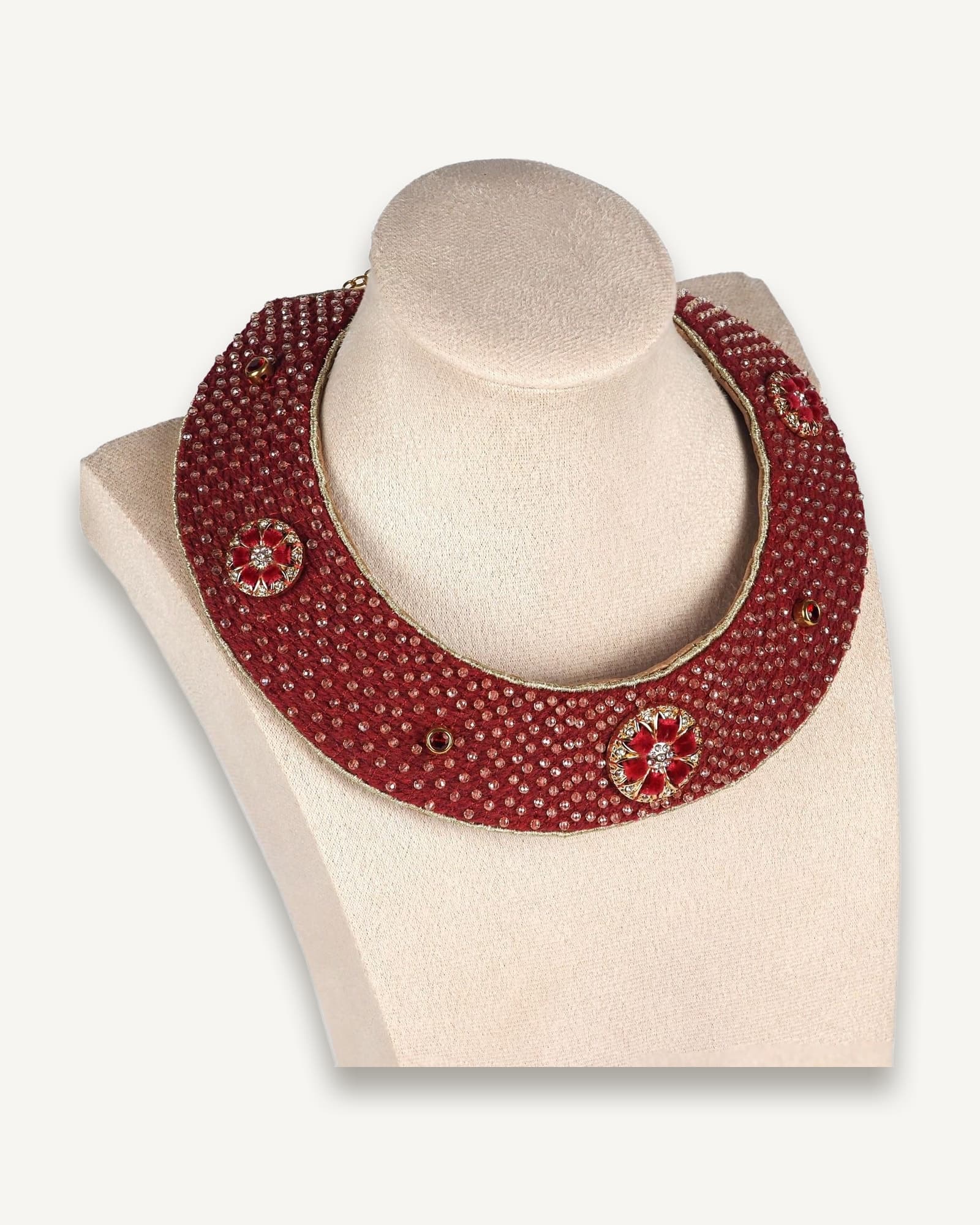 Handmade red collar necklace with gold details and circular motifs, displayed on a mannequin bust, heritage-inspired boho jewellery.