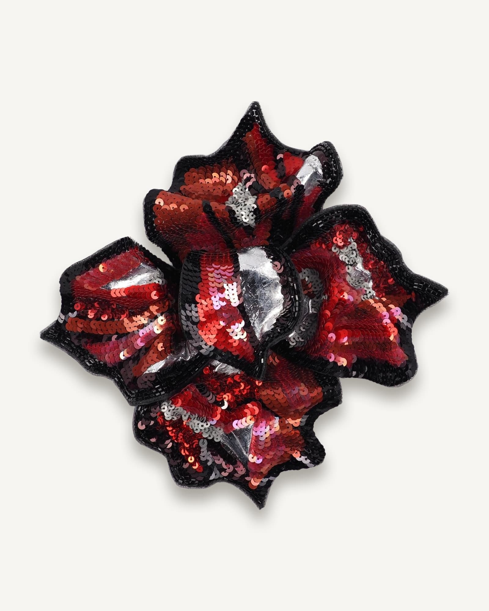 Front view of red and black hand-embroidered floral brooch by Ksenia Semirova, featuring sequins, beads, and silver details on silk organza