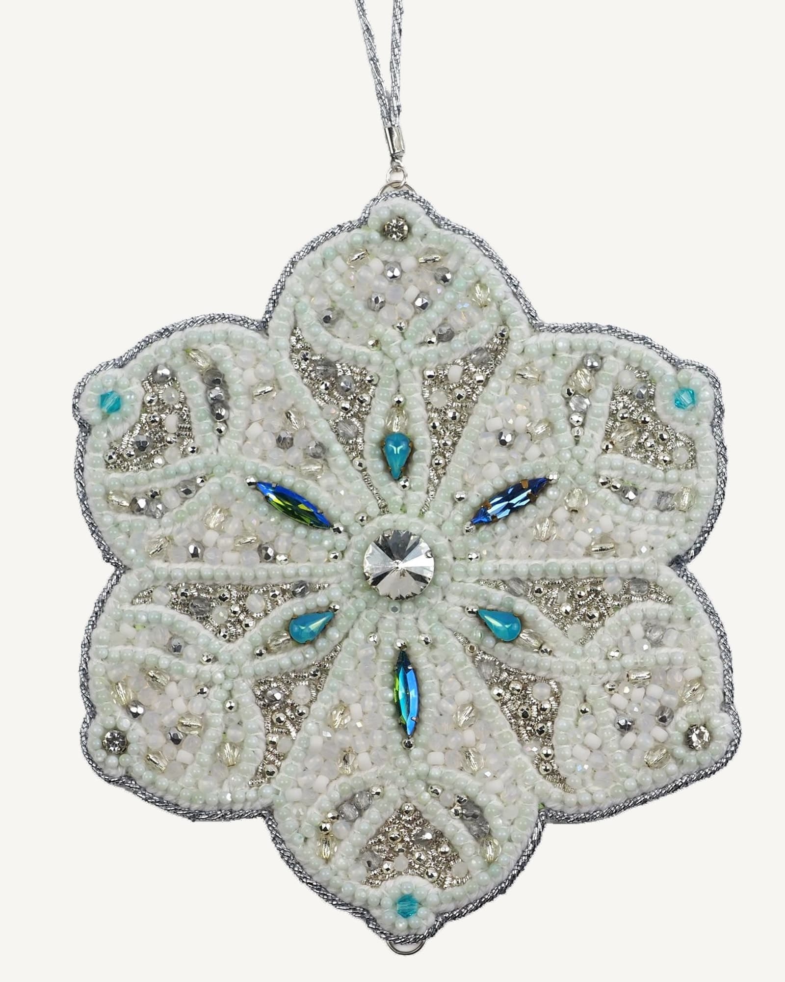 Full view of the Jewels of Winter Six-Pointed Snowflake Ornament by Ksenia Semirova. Hand-embroidered using the pearl-setting technique with white and silver beads, turquoise crystals, and a silver hanging cord.