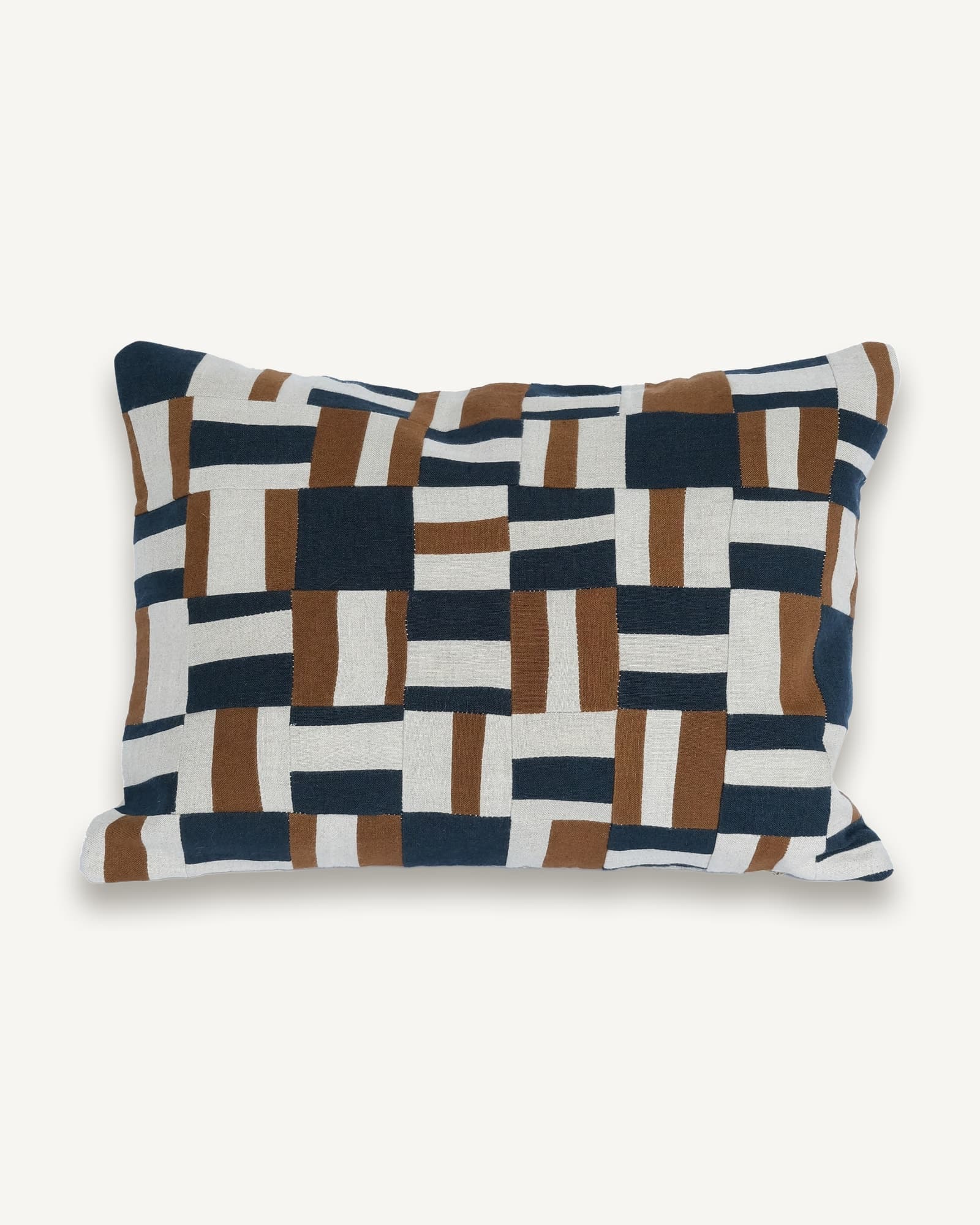 Rectangular linen lumbar cushion with interlocking patchwork in navy, caramel brown and cream