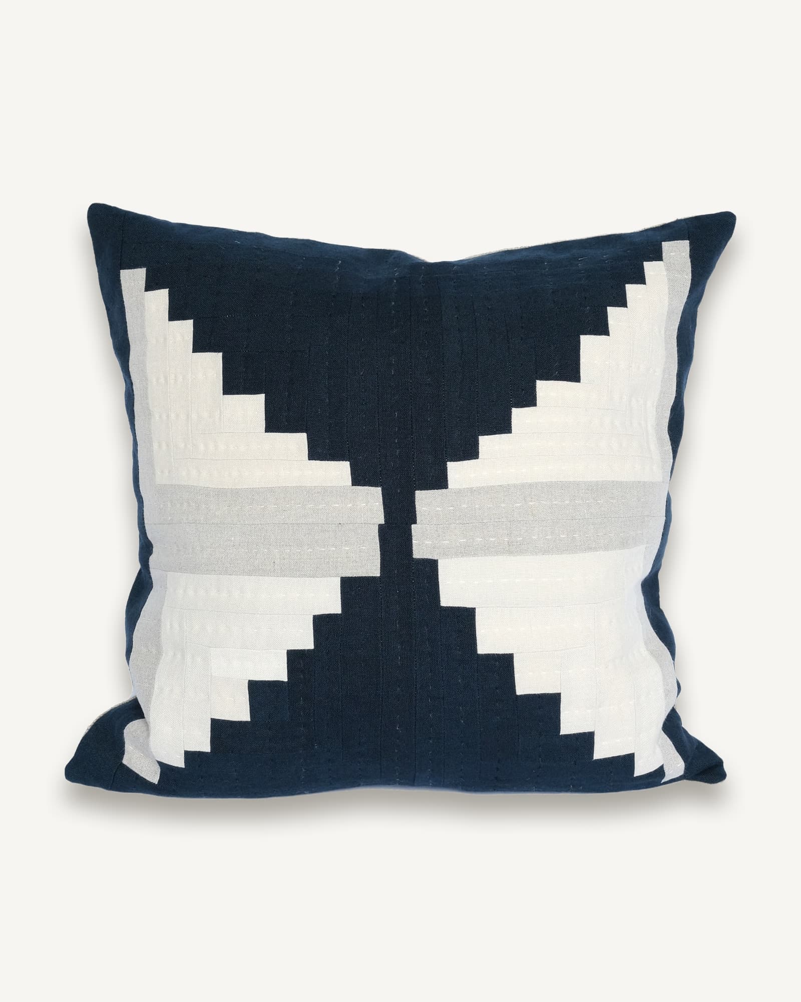 Navy and cream linen cushion with a log cabin patchwork of stepped squares radiating from the centre