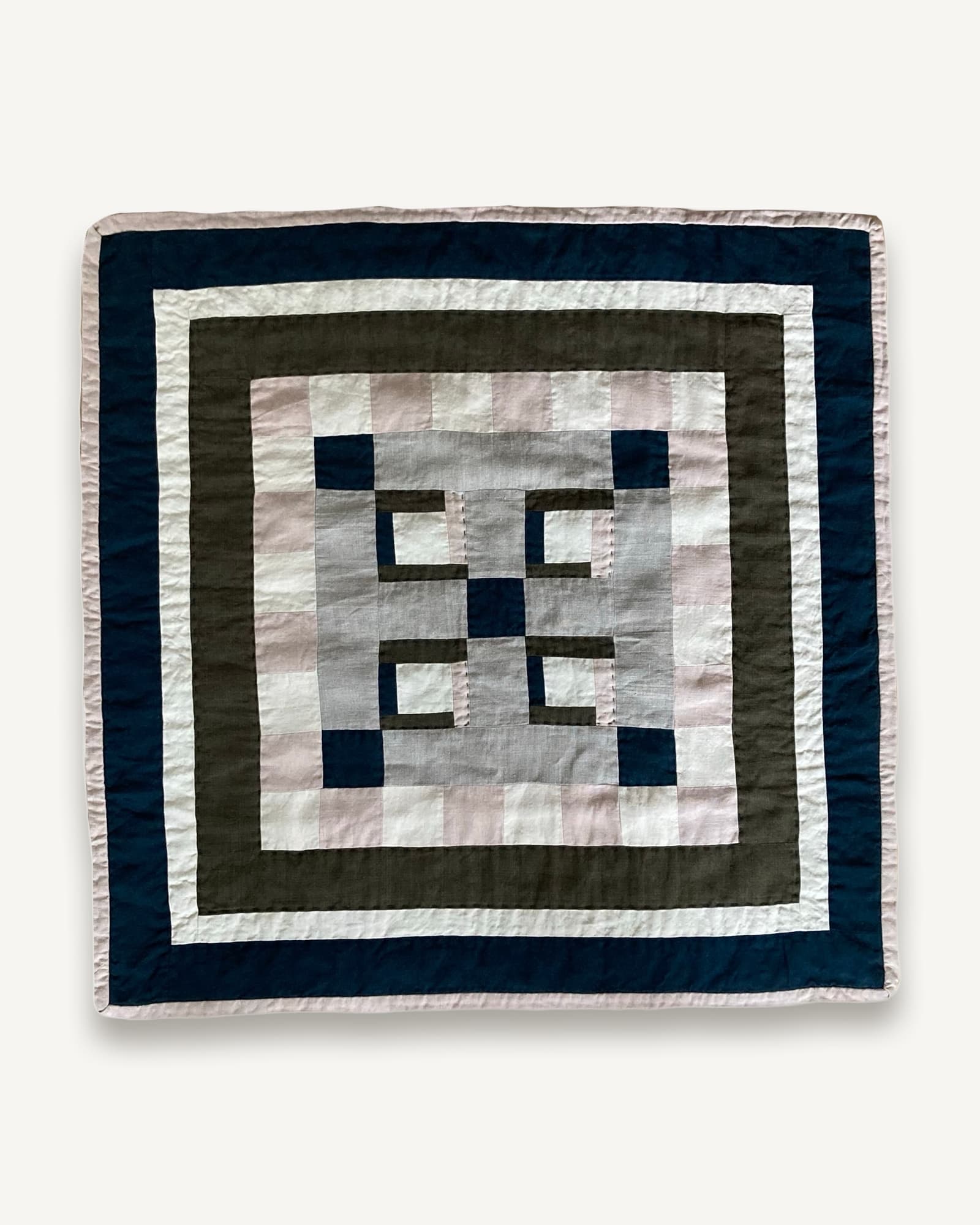 Square patchwork quilt with concentric borders in navy, olive, cream and mauve linen
