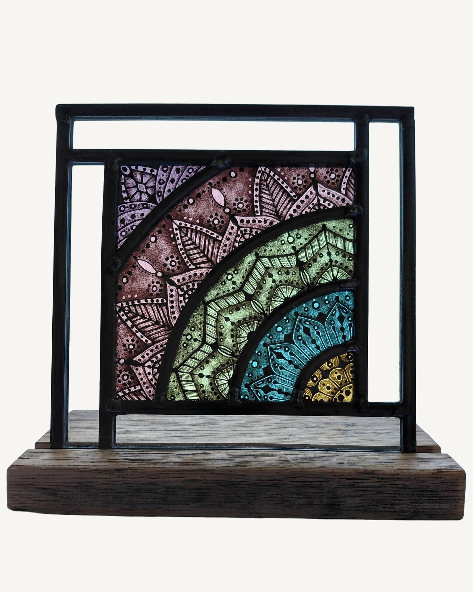 Black-framed glass panel with four curved bands of hand-painted geometric patterns in mauve, sage green, teal and gold