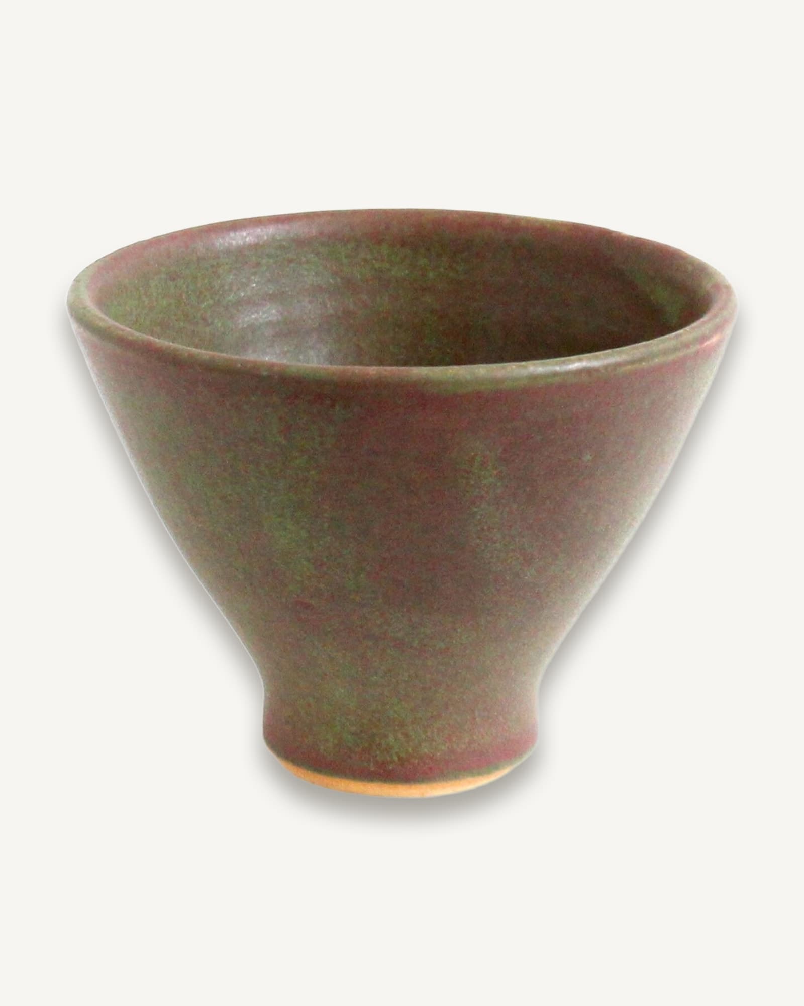 Small footed bowl in mossy green with purple undertones, tapered conical form with satin finish and natural clay base.
