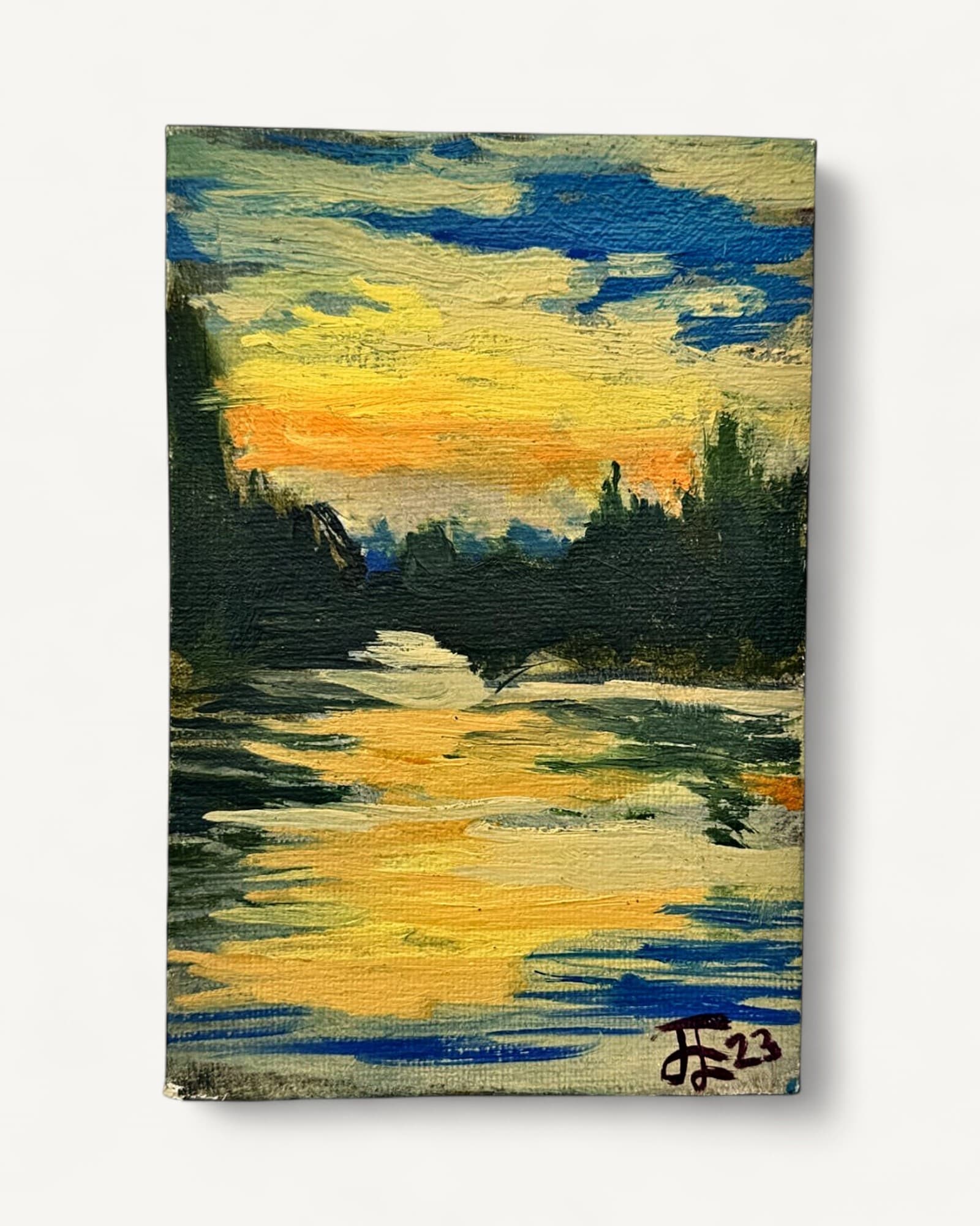 Small oil painting on board depicting a river landscape at sunset, with dark green forested silhouette, golden and orange