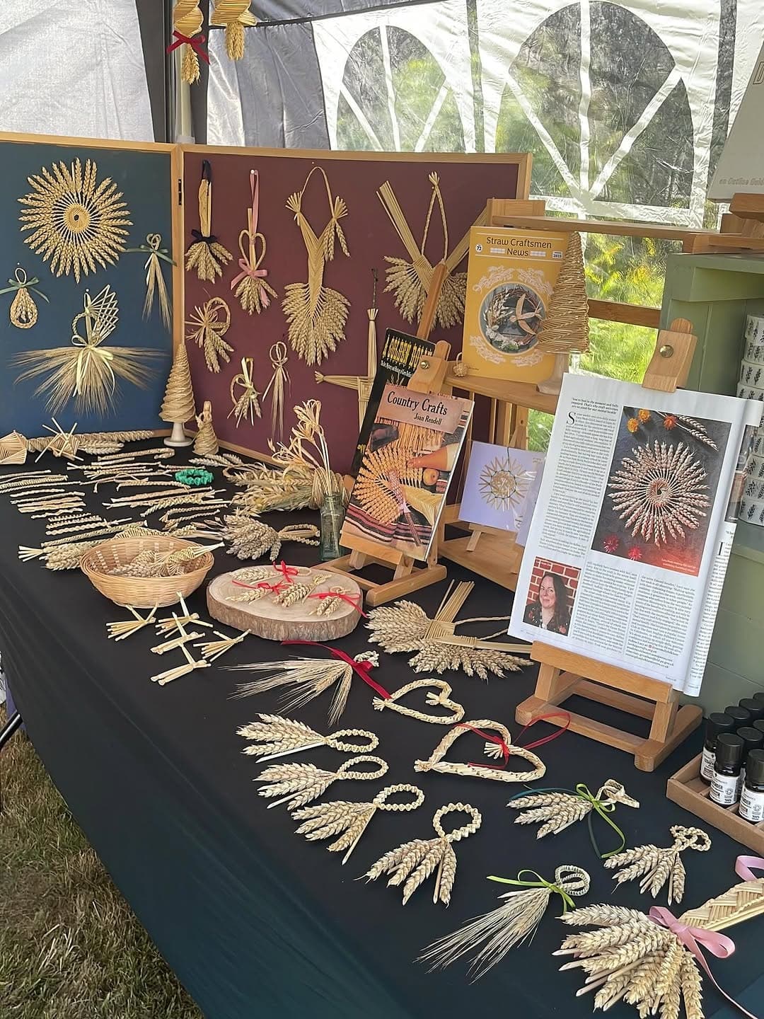 A stall of hanging straw work and corn dollies set up at Ingatestone Hall