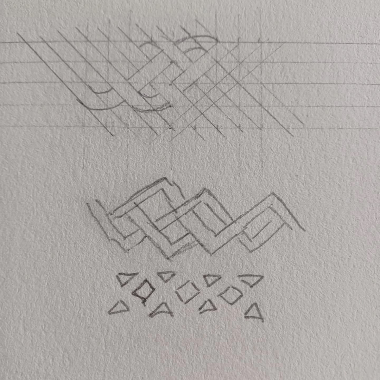A geometric interlace design worked out in pencil on paper, construction grid lines still showing.