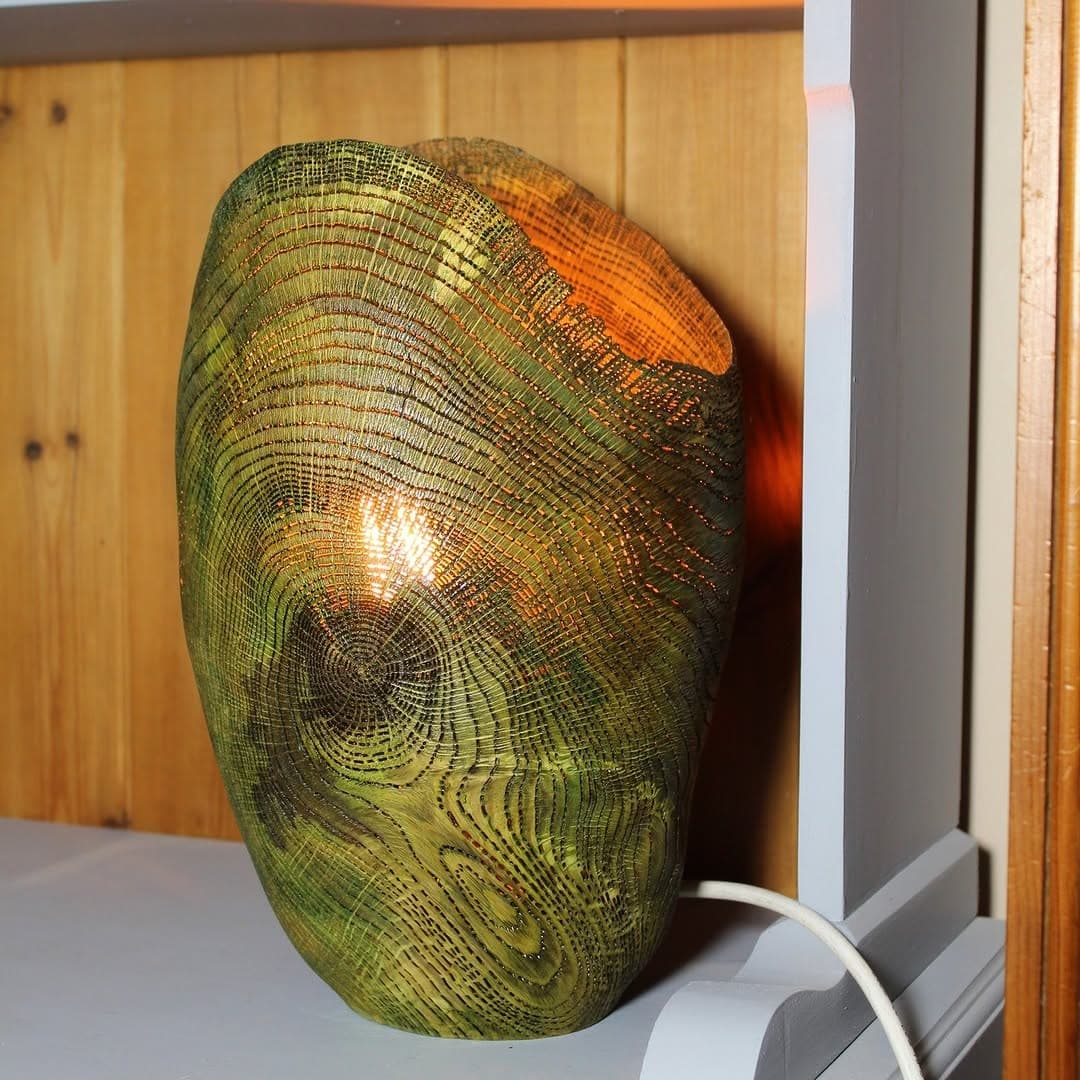 Turned wooden vessel with concentric ring pattern, graduating from deep green at base through yellow to orange-red at top