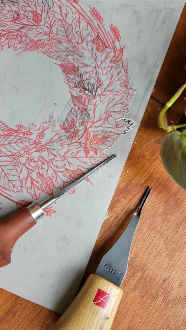 Cutting a wreath block by hand, the gouge in one hand and the block held in the other.