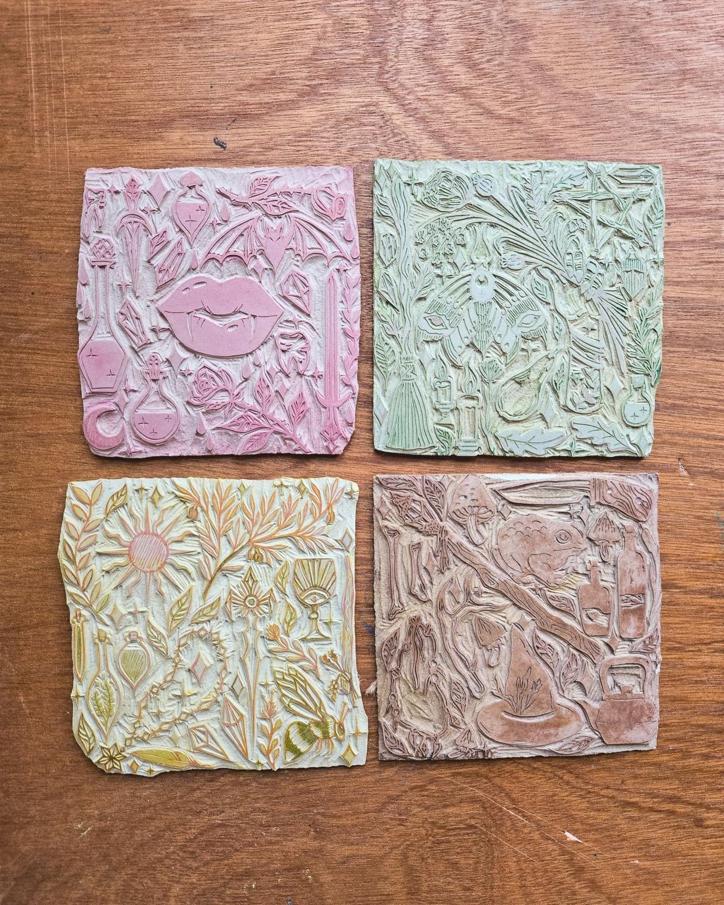 Four blocks left stained by the ink they last printed, in pink, green, gold and brown.