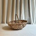 Load image into Gallery viewer, Woven basket on a white surface with beige curtains in the background
