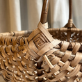 Load image into Gallery viewer, Close-up of a woven basket with a blurred curtain background
